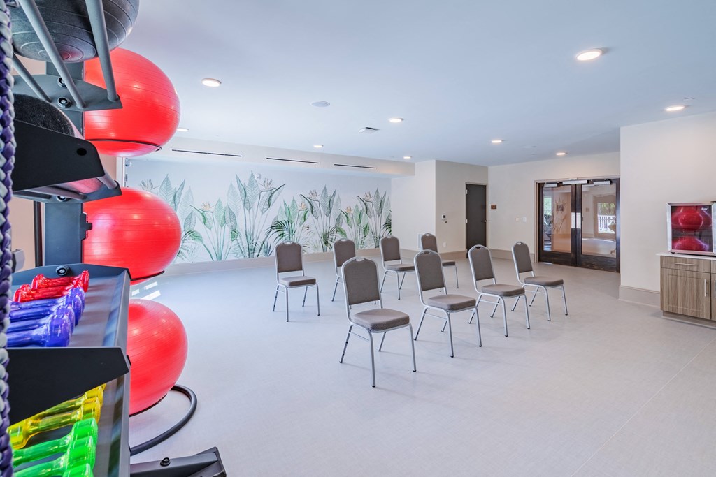 a waiting room with chairs and balloons in the center of it