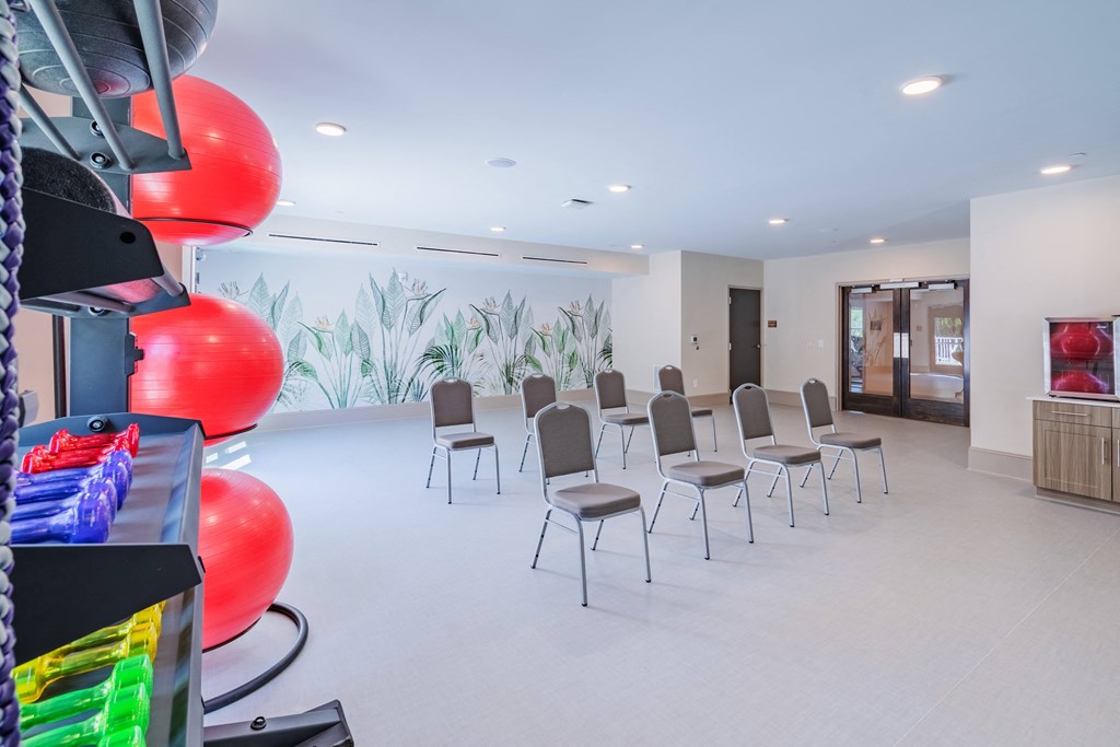 a waiting room with chairs and balloons in the center of it