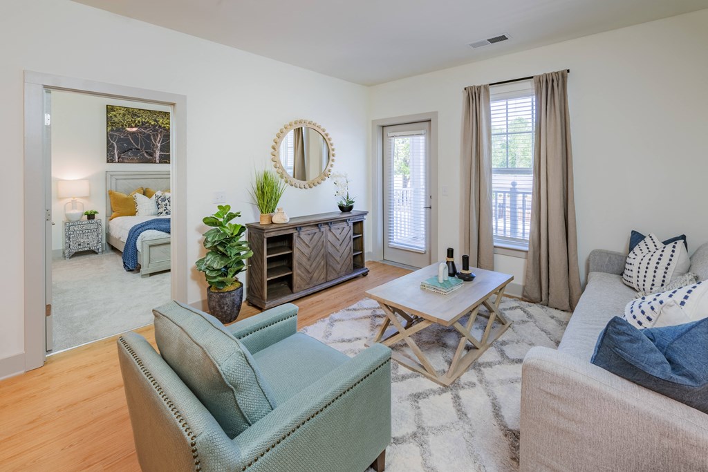 a living room with couches and chairs and a table