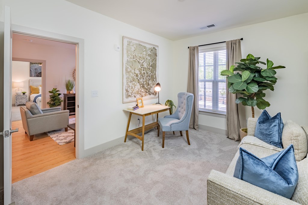 a living room with a couch chairs and a table    and a door