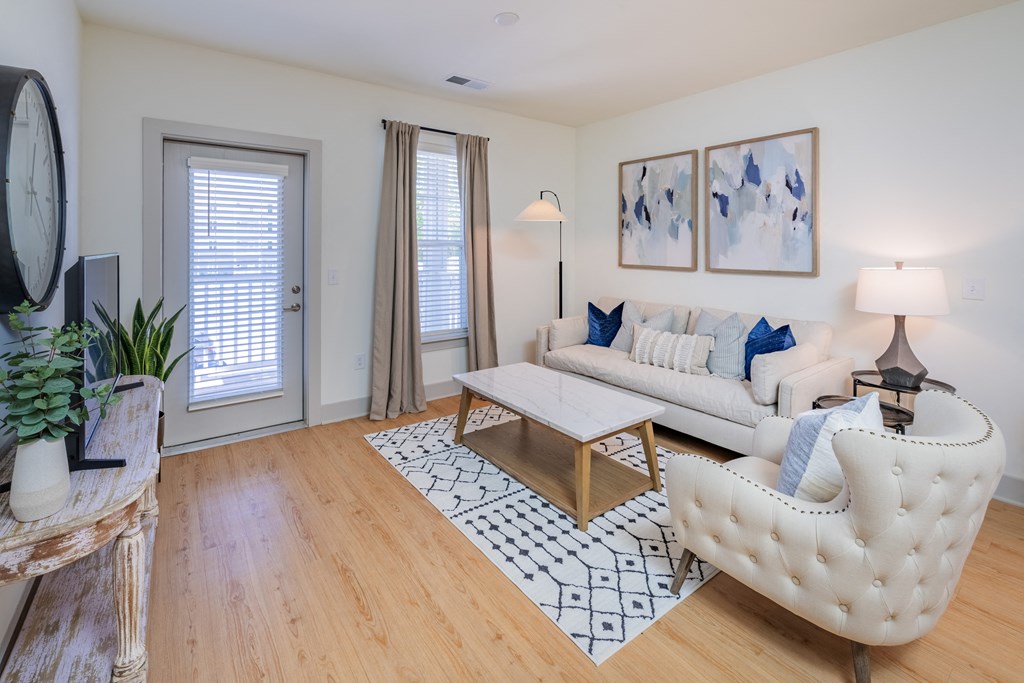 a living room with a white couch and a chair