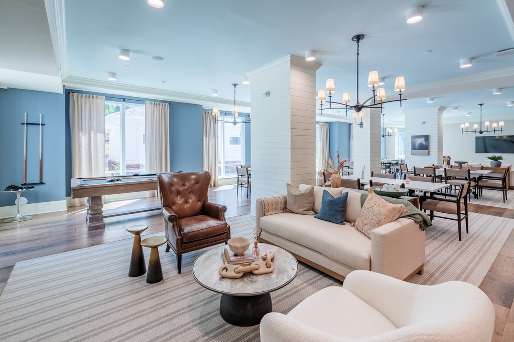 a living room with couches and chairs and a table