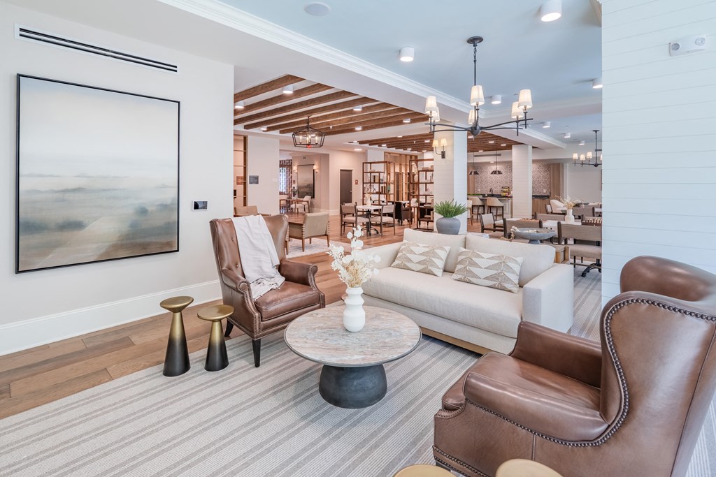 a living room with couches and chairs and a table