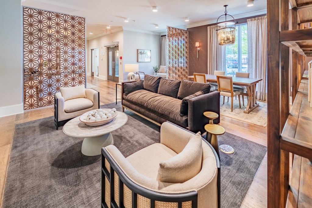 a living room and dining room with a couch and chairs