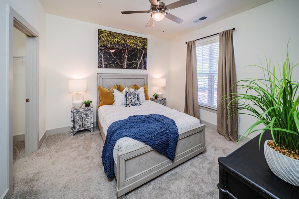 a bedroom with a bed and a ceiling fan