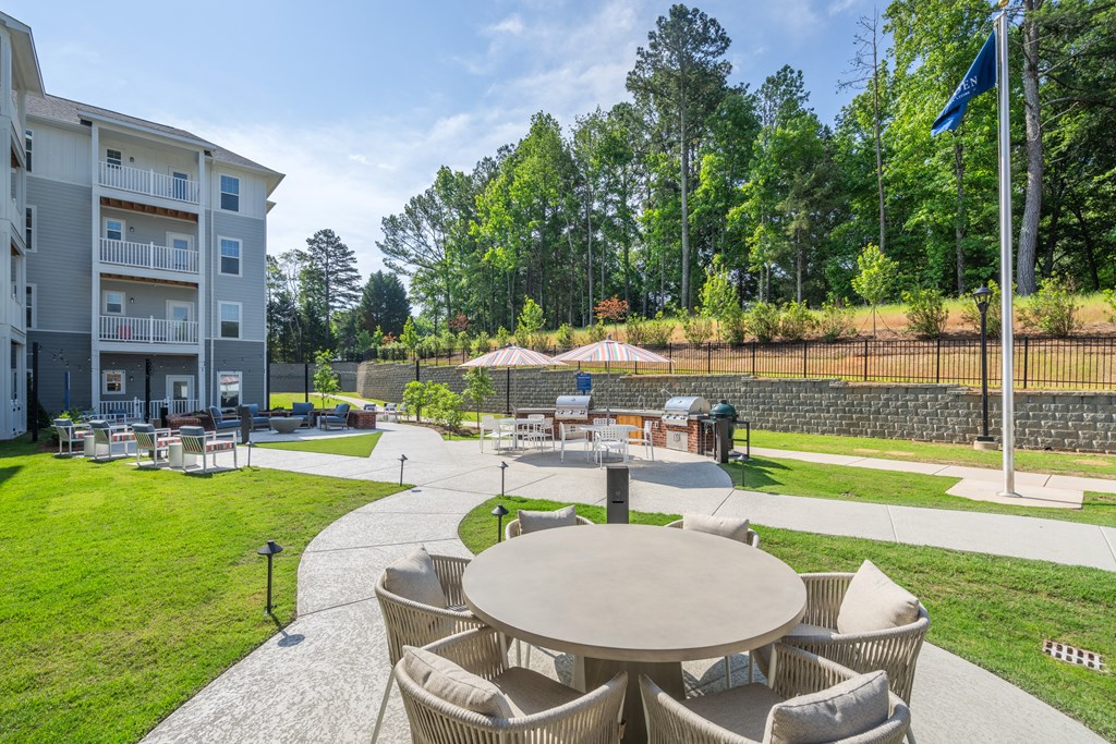 the preserve at ballantyne commons community patio with tables and chairs and a lawn