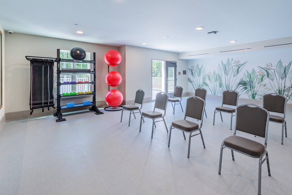 a therapy room with chairs and aacus in the center of a room