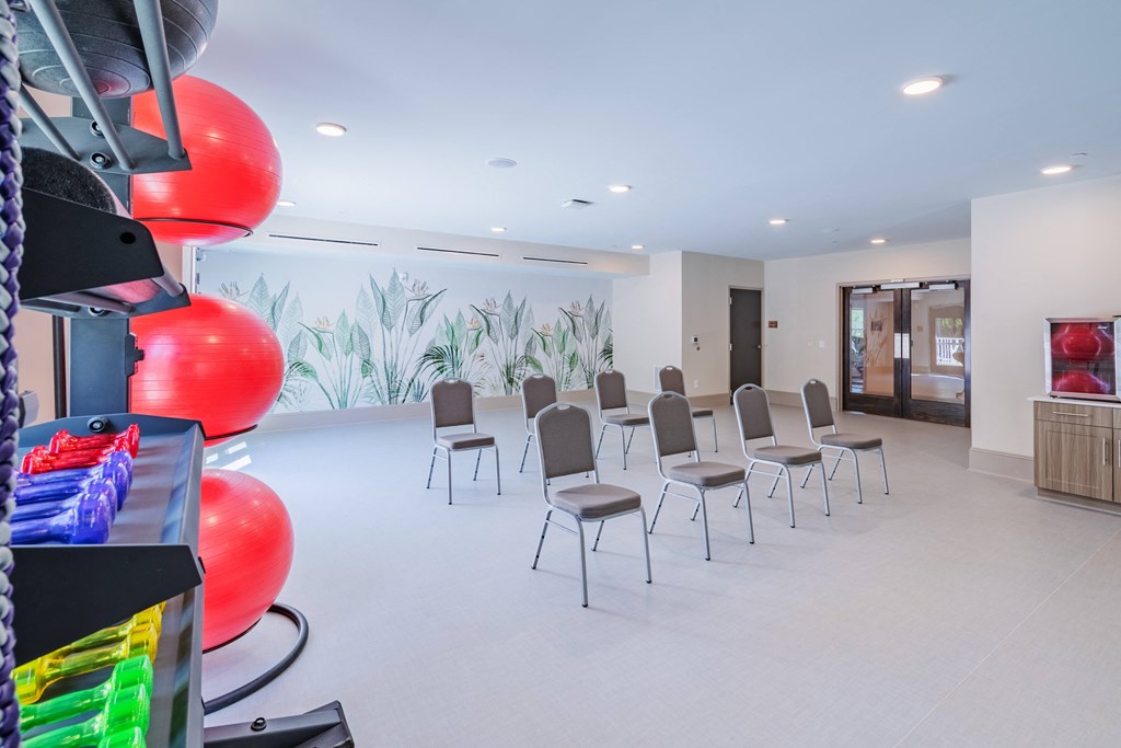 a waiting room with chairs and balloons in the center of it