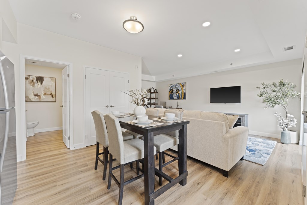 A dining room with a table set for four.
