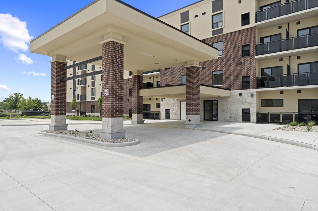 A large building with a covered walkway in front.