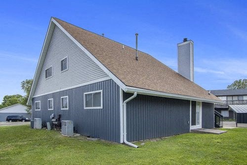 a gray building with a brown roof