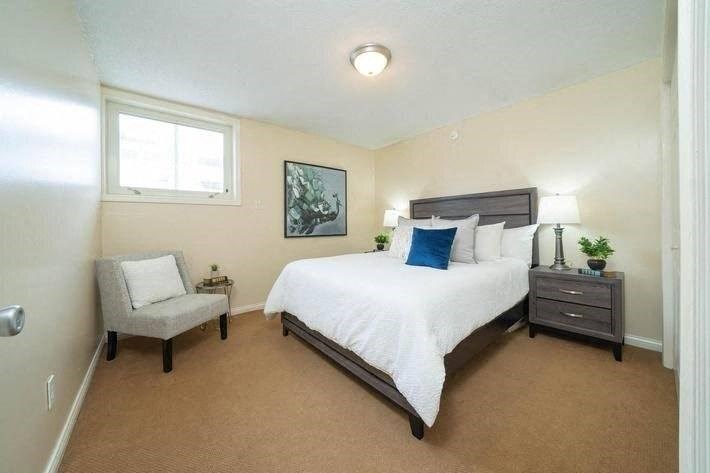 a bedroom with a bed and a chair