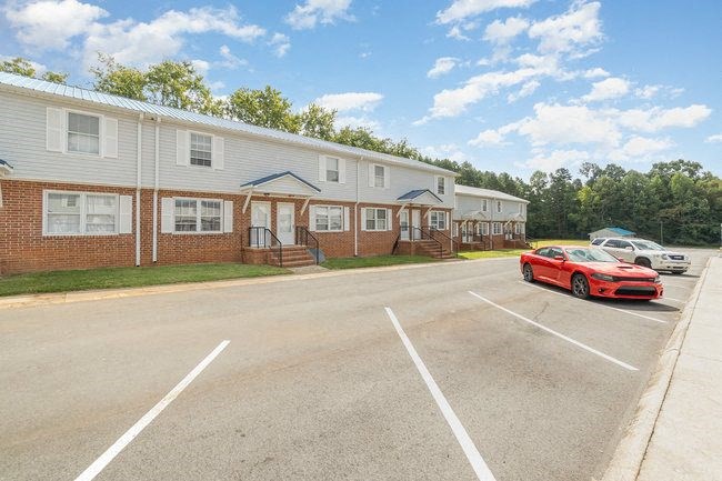 a red car is parked in a parking lot