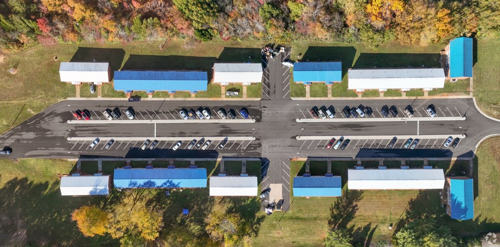 an aerial view of the parking lot of a car dealership