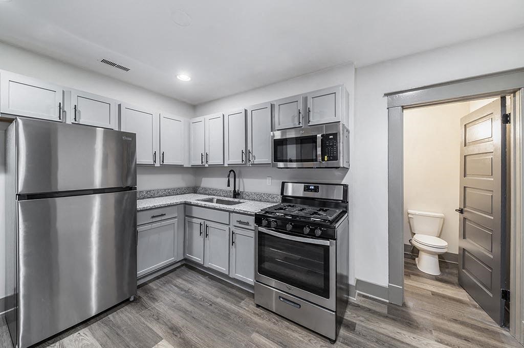 a kitchen with stainless steel appliances and white cabinets