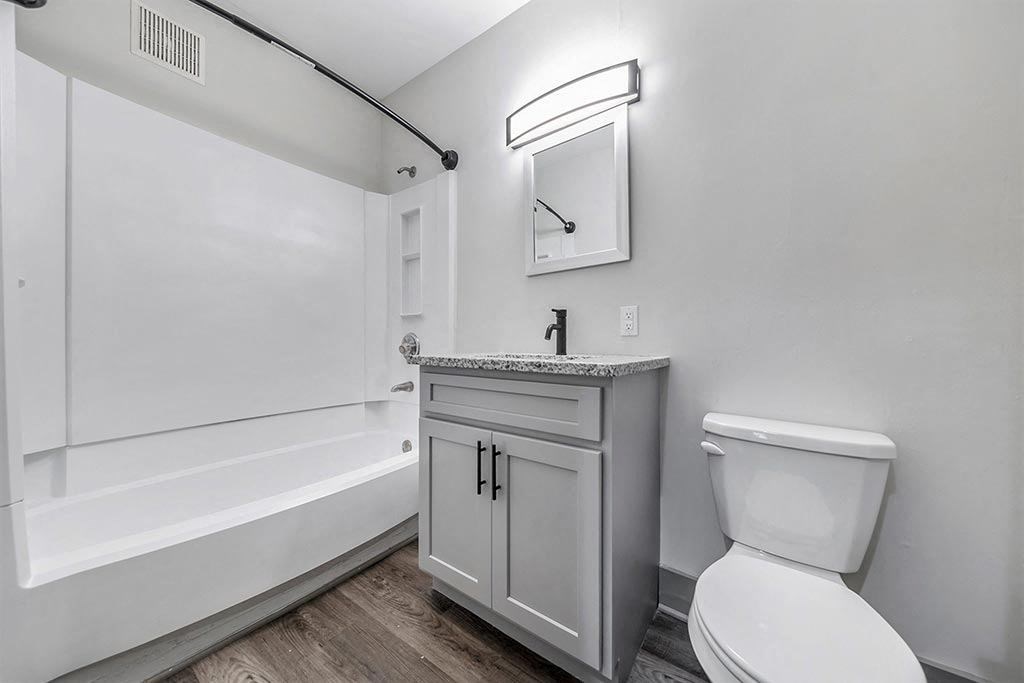 a white bathroom with a toilet and a sink