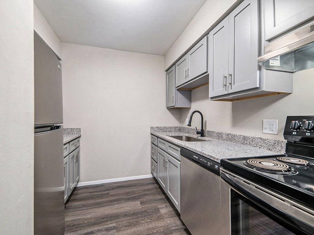 a kitchen with stainless steel appliances and white cabinets