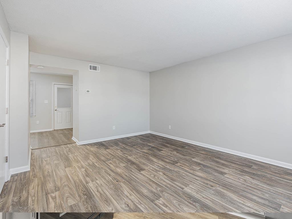 an empty living room with a wood floor