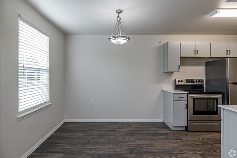 A kitchen with a stove top oven and a microwave.