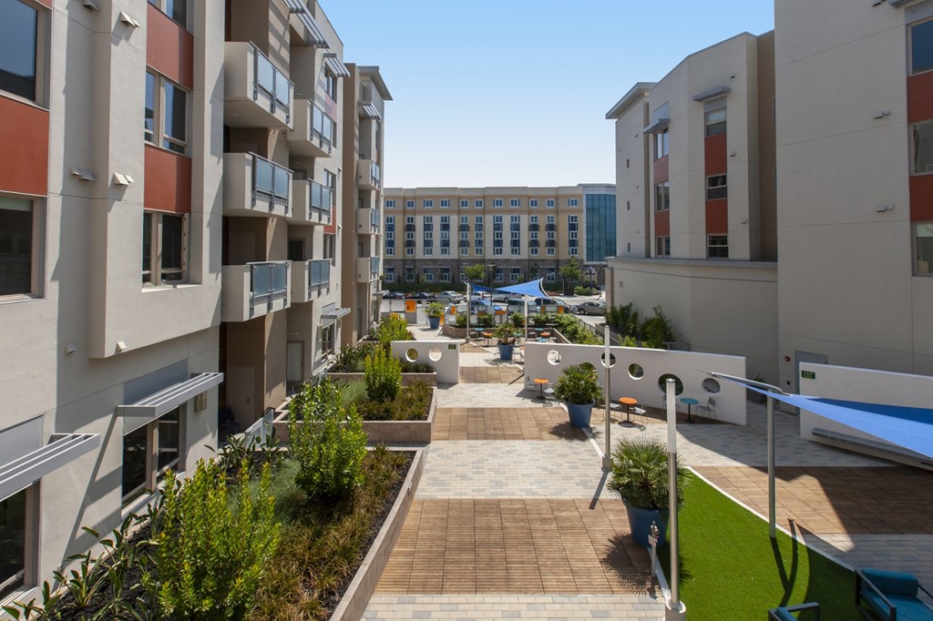 a view of an apartment complex with a courtyard in the background of Main Street Lofts Cupertino