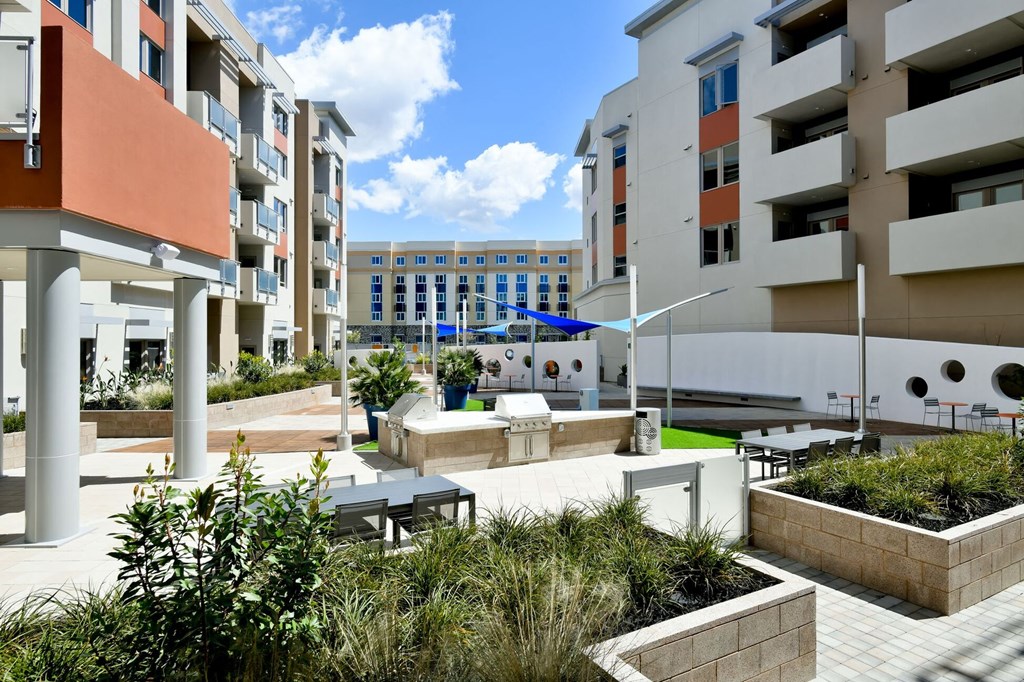 a courtyard with a fountain and seating area at Main Street Lofts Cupertino