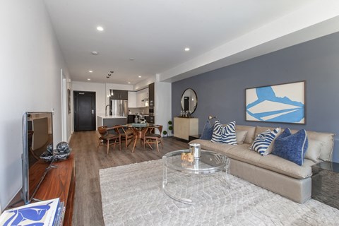 A living room with a grey couch and a coffee table.