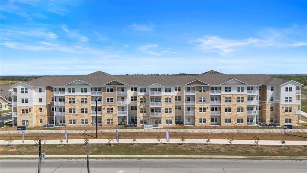 A large apartment complex with multiple buildings and balconies.