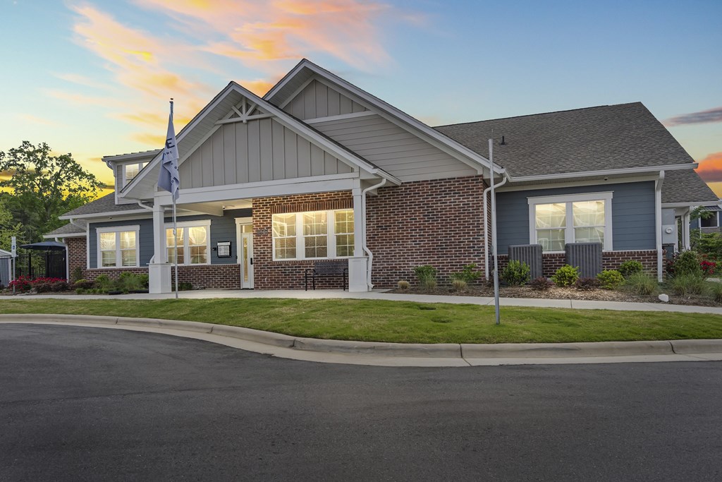 A house with a flag on the front lawn.