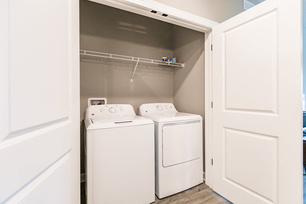 a washer and dryer in a laundry room with white doors