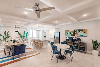 a dining room and kitchen with a table and chairs