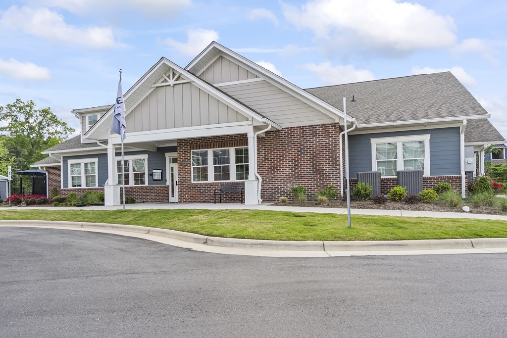 A house with a grey roof and a flag on top.