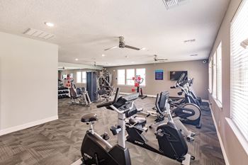 fitness center with cardio equipment and weights at swiftwater luxury apartments in port charlotte