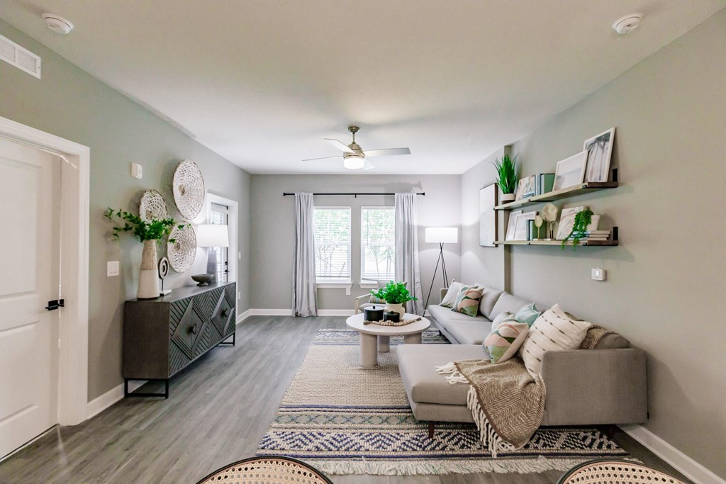 a living room with a couch and a table at Vantage Luxury Apartments in Cape Coral, Fl