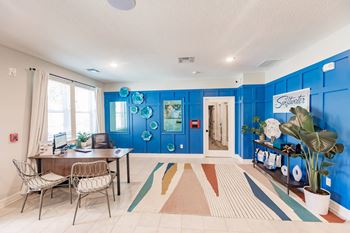 a living room with blue walls and a table and chairs