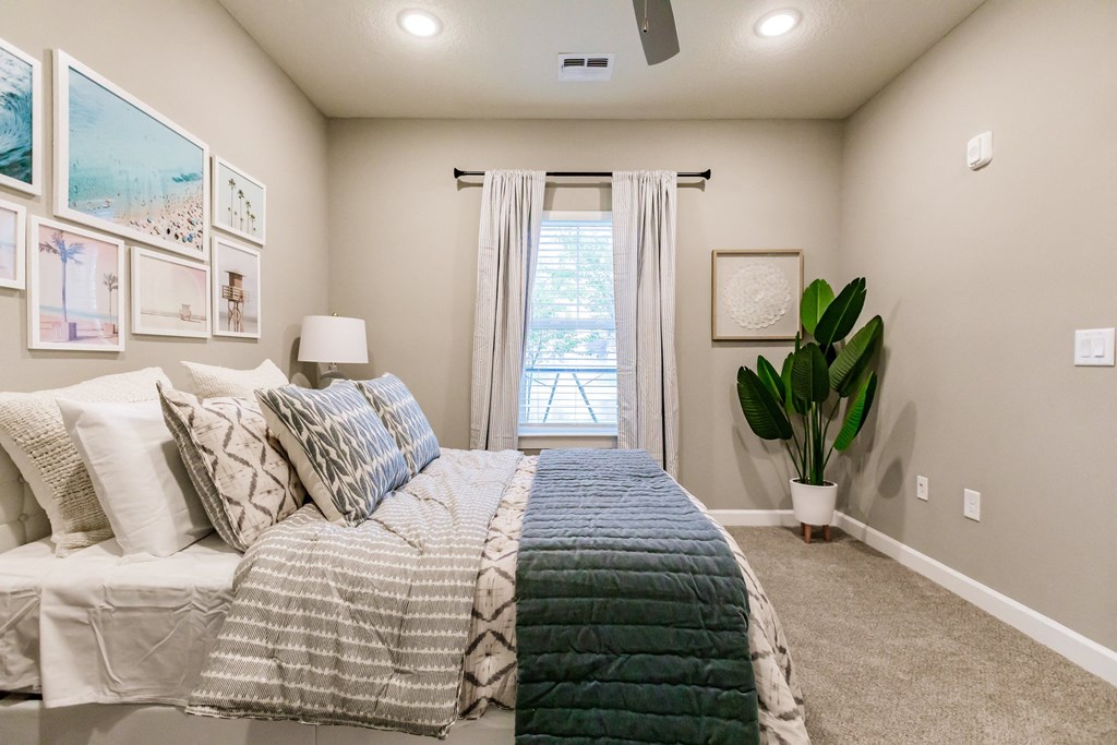 an empty bedroom with a bed and a window