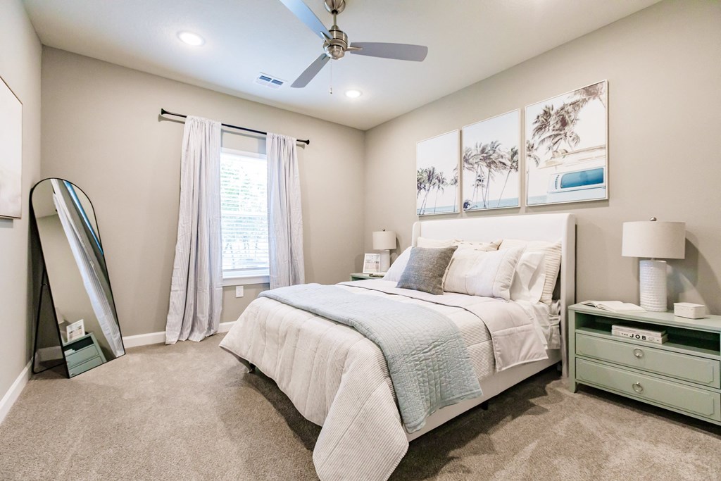 a bedroom with a bed and a ceiling fan