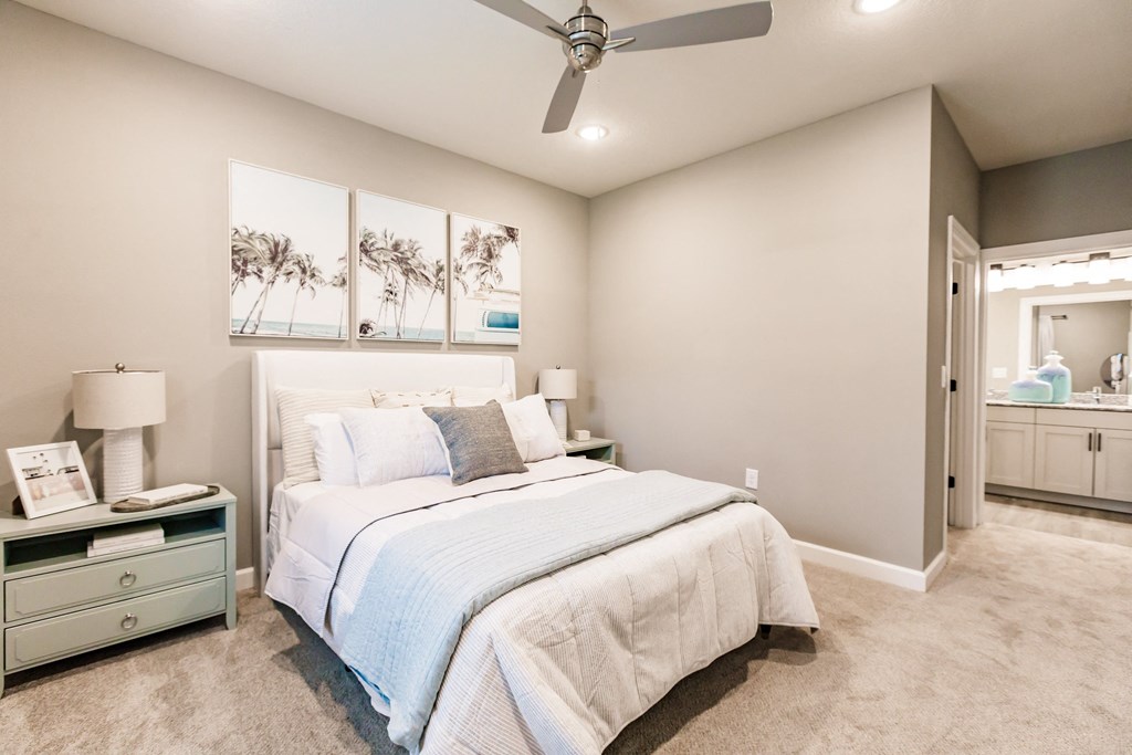 a bedroom with a bed and a ceiling fan