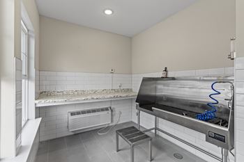 A clean, empty kitchen with a stainless steel oven and a small table.