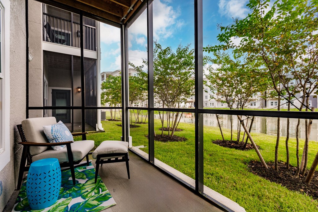 a screened in balcony with a chair at Vantage Luxury Apartments in  Cape Coral, FL