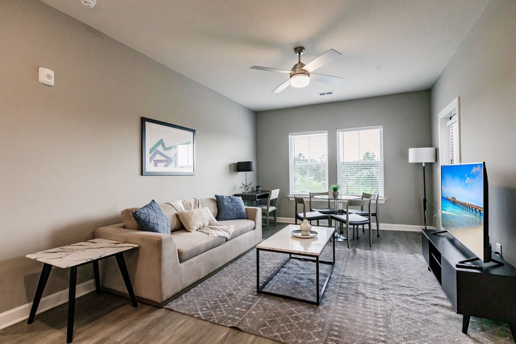 an open living room and dining room with a couch and a tv