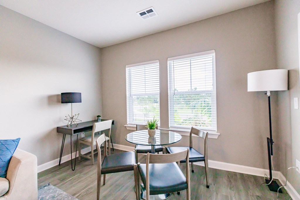a living room with a table and chairs and a couch