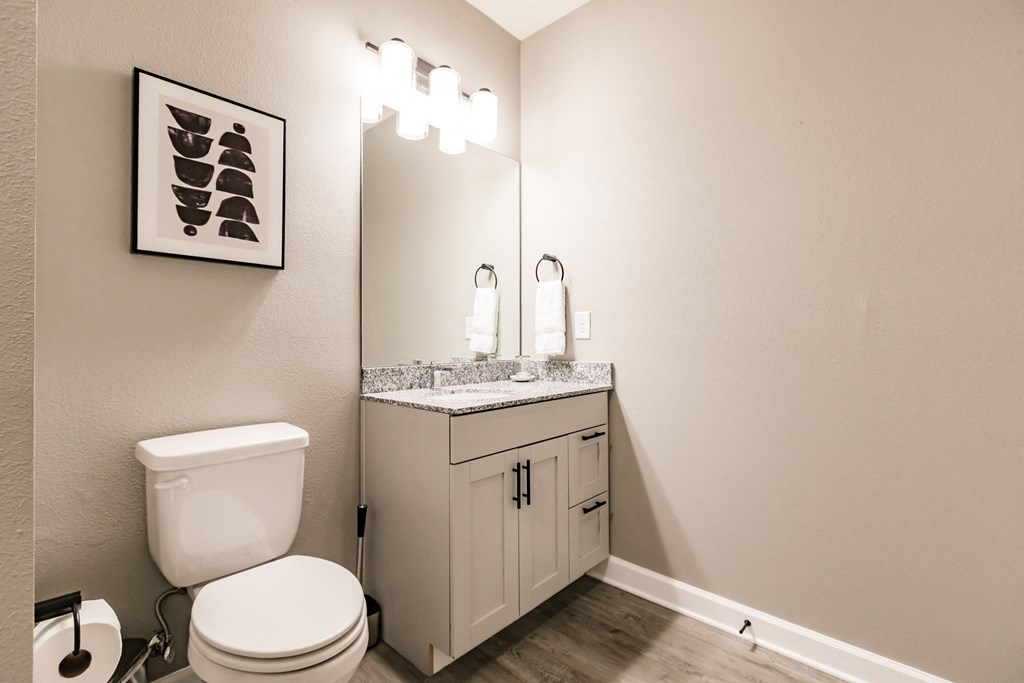 a bathroom with a toilet and a sink at Vantage Luxury Apartments in  Cape Coral, FL