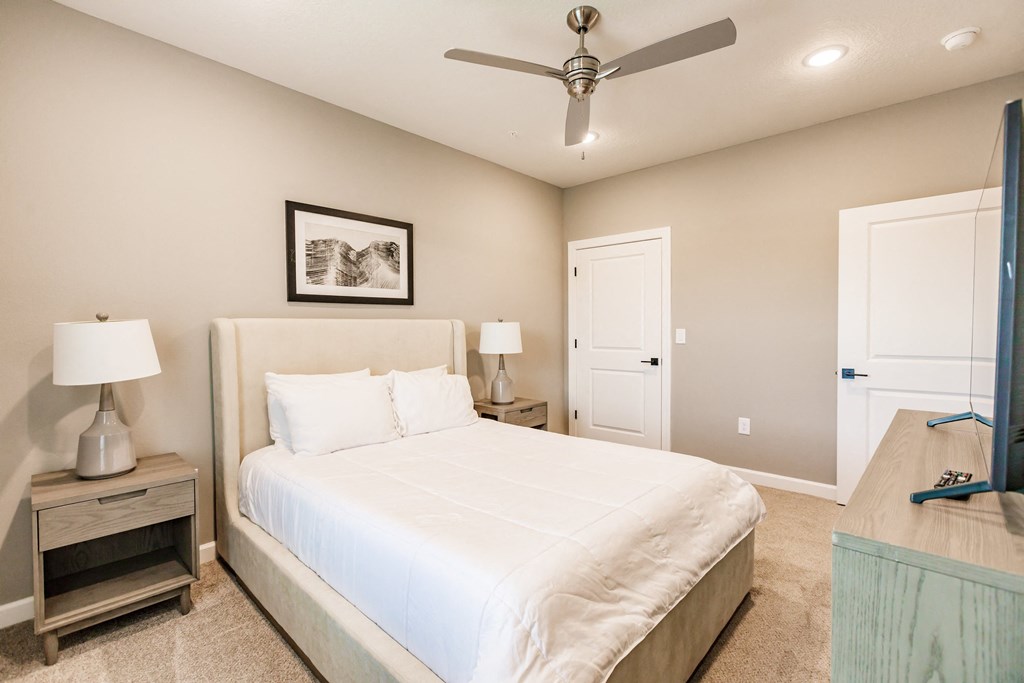 a bedroom with a night stand at Vantage Luxury Apartments in  Cape Coral, FL