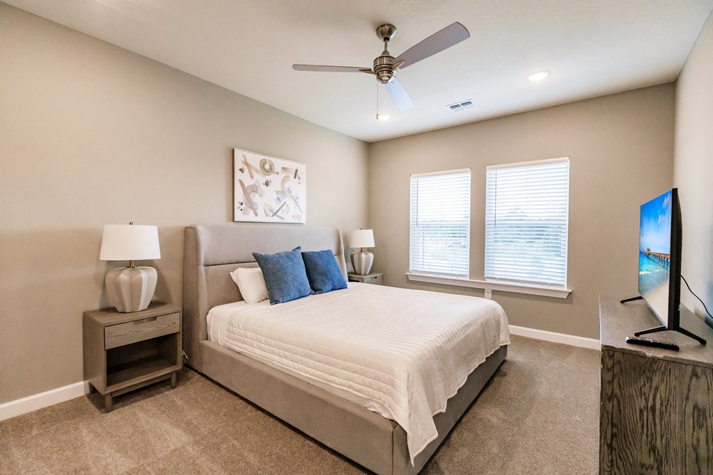 a bedroom with a bed and night stand at Vantage Luxury Apartments in  Cape Coral, FL
