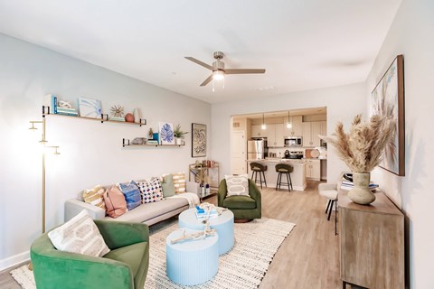 a living room with furniture and a ceiling fan