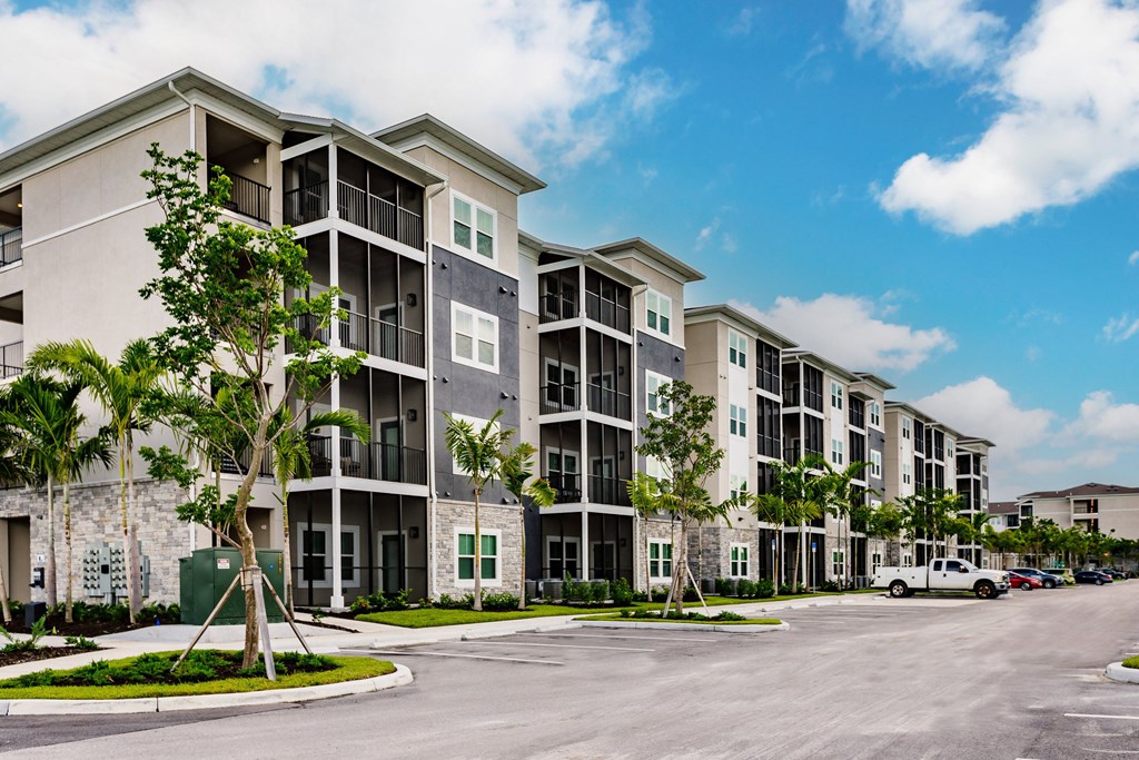 Vantage apartment building with trees and a parking lot