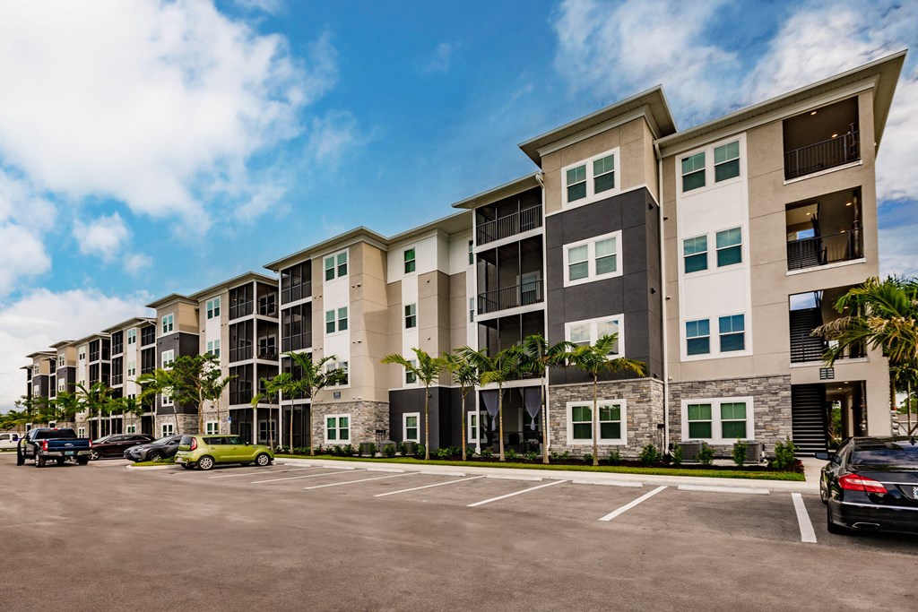 an empty parking lot in front of Vantage apartment building