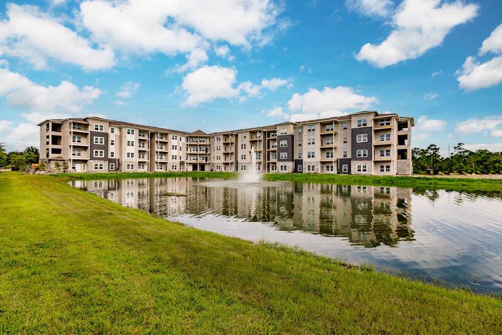 a large pond in front of an apartment building