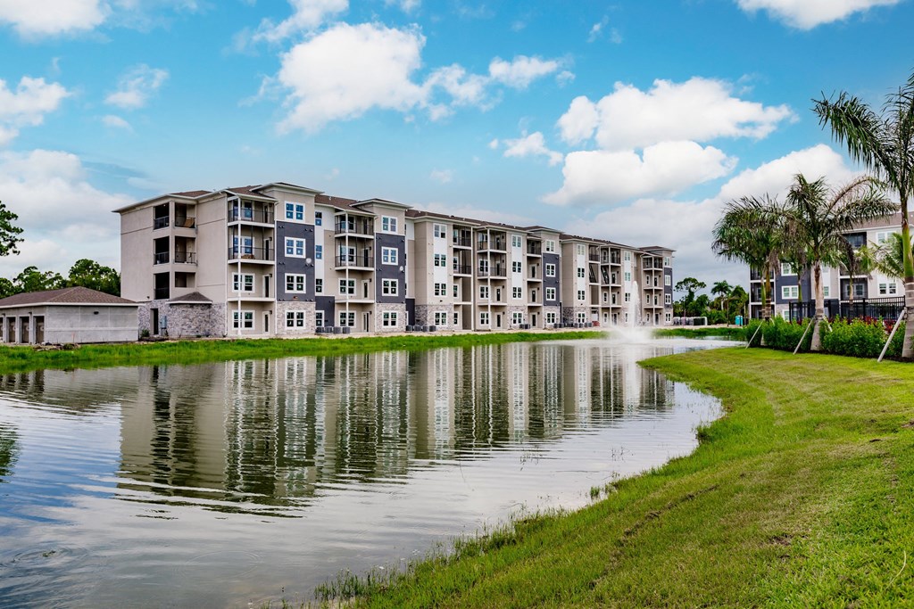 Vantage apartment building overlooking a pond with a fountain