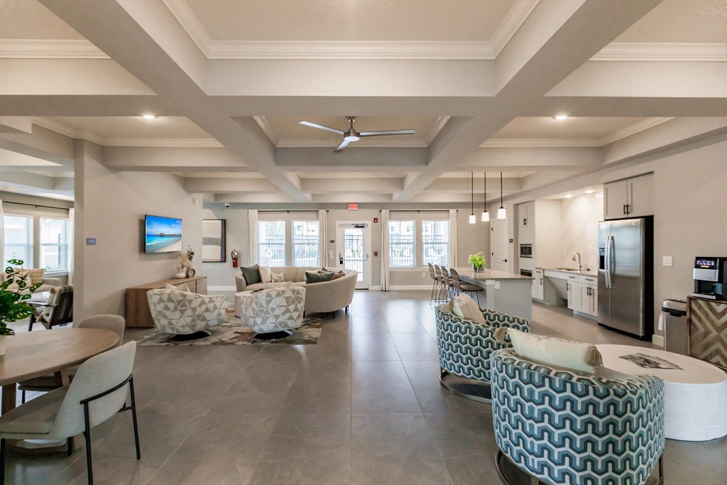 community lounge area with chairs and tables at Vantage Luxury Apartments in  Cape Coral, FL